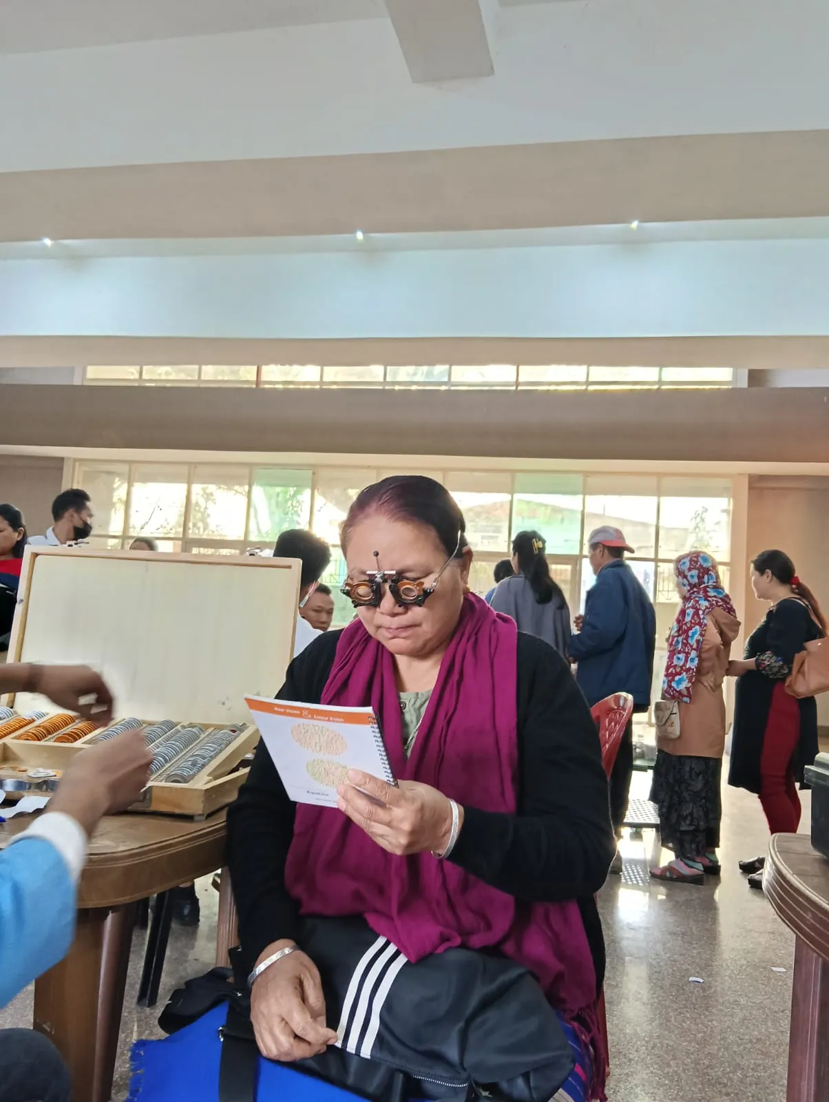 Distributing free prescription spectacles to camp beneficiaries.